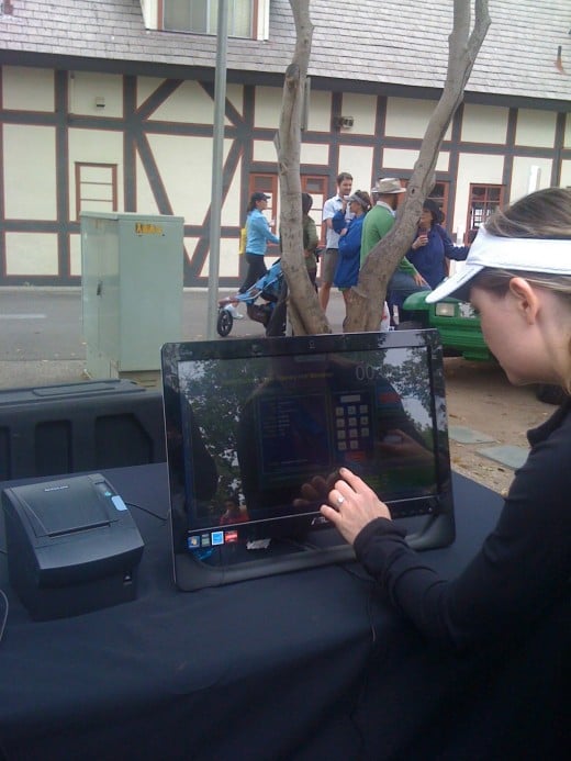 A runner gets her digital race results, which can be printed minutes after finishing