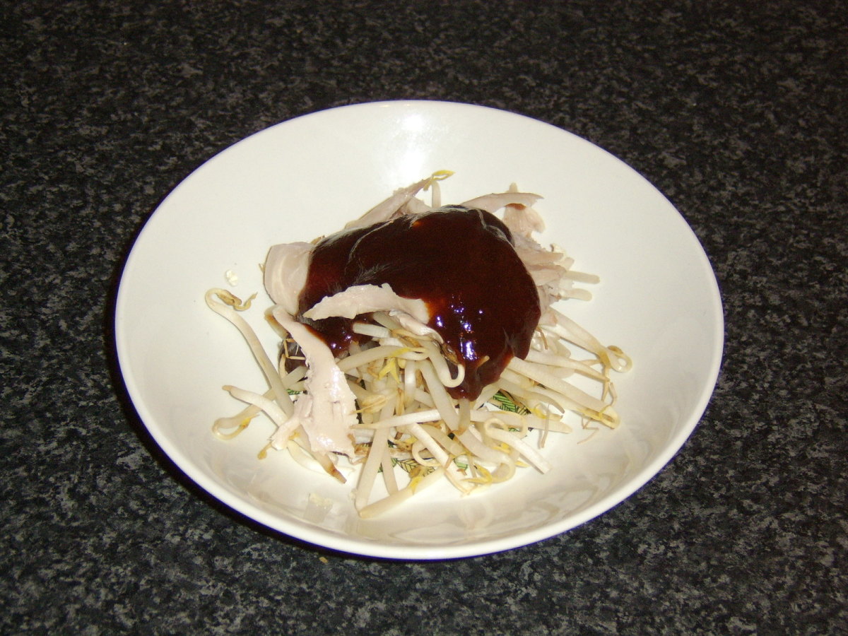Chicken is mixed with the beansprouts and the hoisin sauce