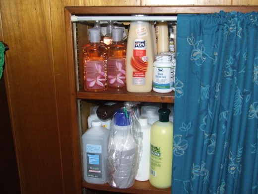 I keep my body wash, shampoo and homemade products in this built in book shelf.  I put a tension rod up with a homemade curtain to conceal everything.