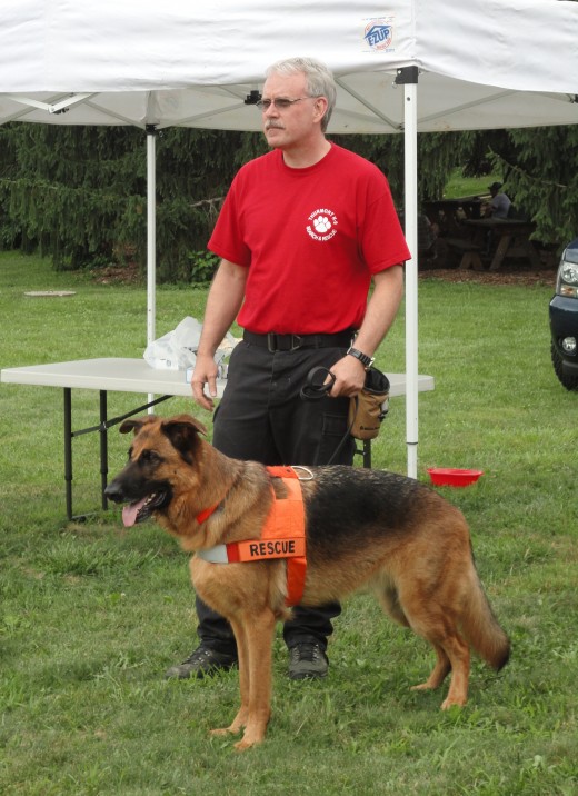 Image of Bill Blackwelder of Thurmont-Frederick, Md. area with his canine search and rescue partner, Largo, a German Shepherd.