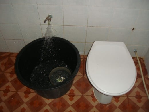 Bathroom or "Hong Nam" (Room Water) of a 800 baht bungalow You must dip water from the black tub to flush