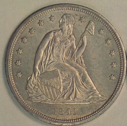 Seated Liberty on the front of the silver dollar.
