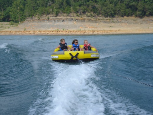 Enjoy summer rafting while being pulled behind a larger boat.