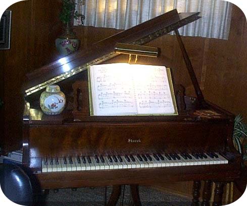 My little spinet grand in my den, occupying 4 feet x 4 feet with 11 keys short  keyboard. 
