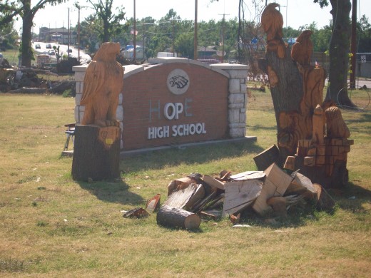 Joplin High School sign redone.  The carvings are made from destroyed trees on the property.