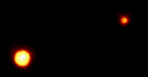 Pluto and its moon Charon, as photographed by the Hubble Space Telescope.