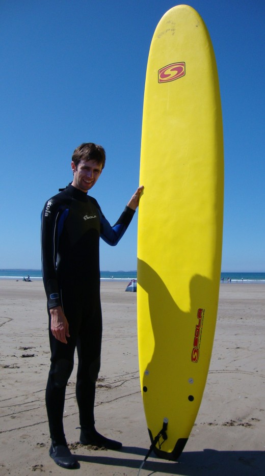 Catching a wave: A surfer poses with their board at Newgale
