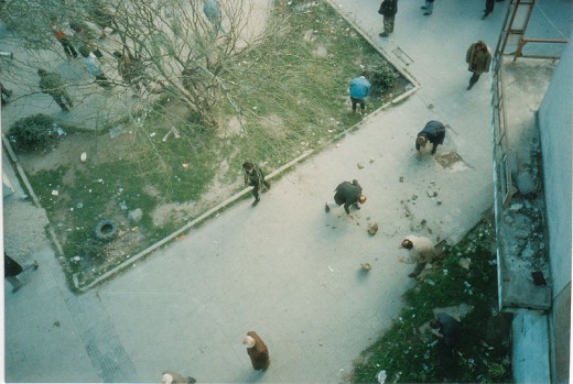 Citizens of Vlore, Albania gathering rocks to throw at police during the riots
