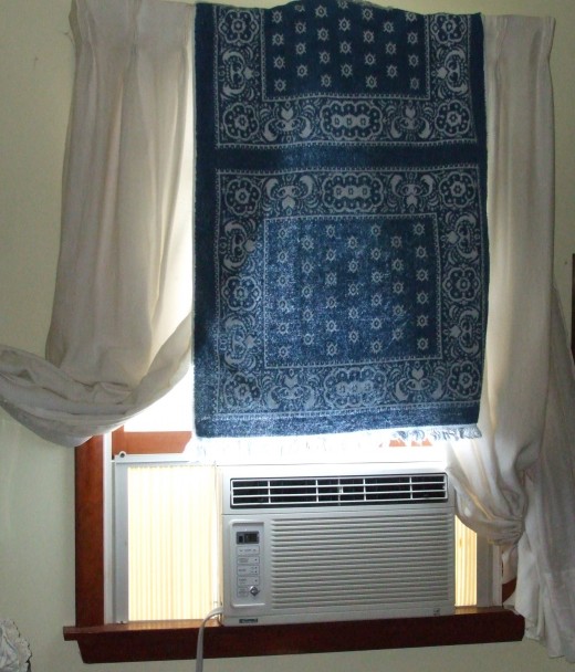 A towel hung at the window blocks heat from sunlight.