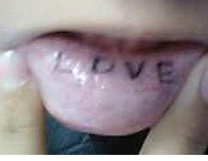 Partially faded lip tattoo