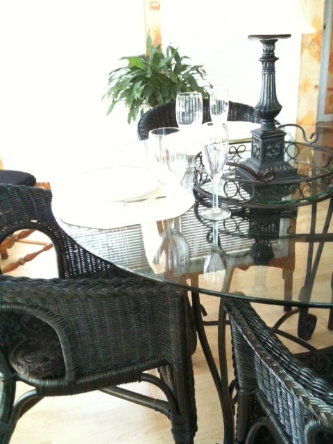 Repainted and repurposed wicker chairs moved to sunny breakfast nook for a cheap decorating idea.