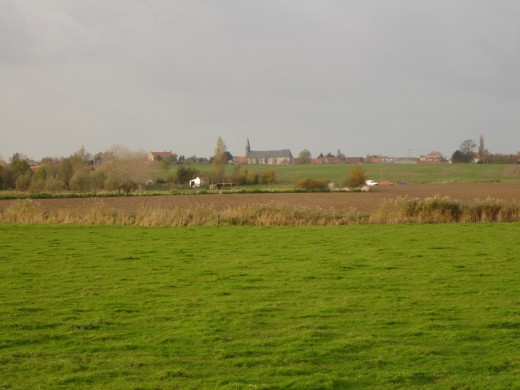 Village of Oost-Cappel, Nord, Nord-Pas de Calais, France. The small village and church, as seen from Roesbrugge-Haringe in Belgium.