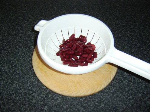 Canned red kidney beans are firstly washed through a colander before being incorporated in the beef chilli