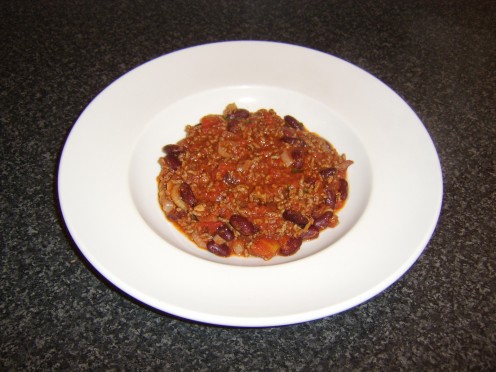 The beef chilli is plated and ready to be garnished and served