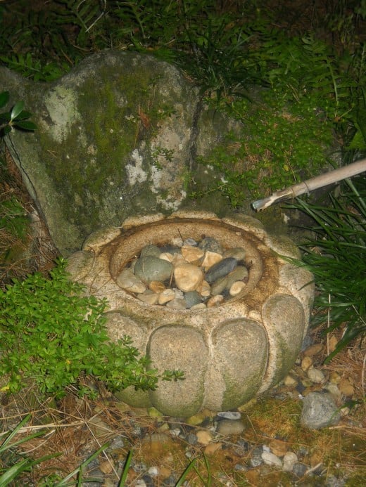 Stone pot with pebbles and water