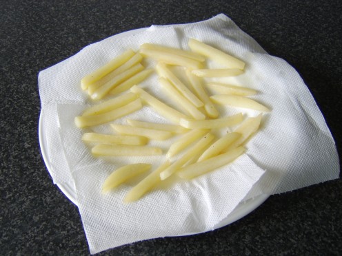French fries after their first fry, essentially cooked but not yet crisp or golden