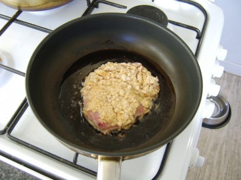 The breaded turkey steak is shallow fried in oil