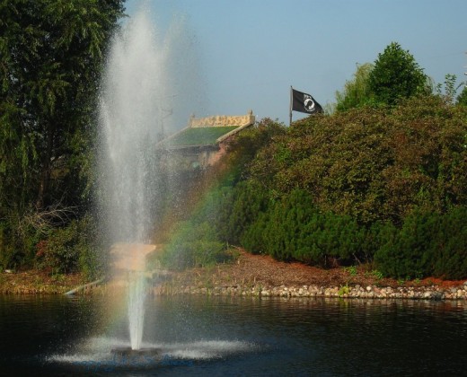 The beautiful fountain creates a rainbow but the POW Flag flying in the landscape quickly reminds us of the ugliness of war.