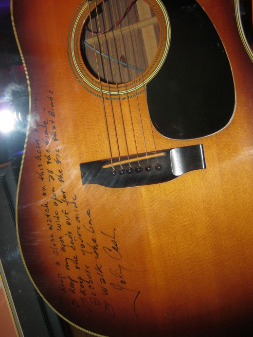 Guitar signed by Johnny Cash, includes the first few lines of "I Walk The Line"
