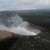Pu'u O'o, Nov 2009. On the horizon, the main summit crater of Kilauea Volcano is also erupting. Kilauea is a huge, flat "shield volcano" which is thousands of feet high, but its lavas spread out almost horizontally, building like a giant mud patty.