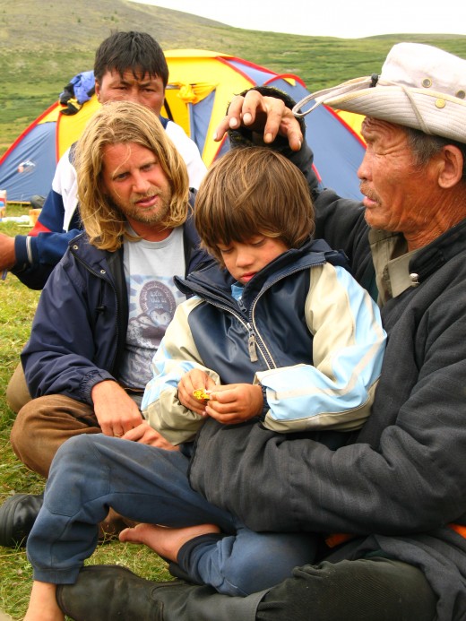 Horse Boy author Rupert Isaacson and his son Rowan sit with a Shaman healer in Mongolia