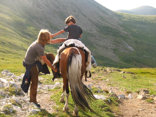 Rupert gets up onto a horse with Rowan