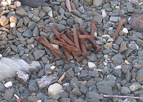 Rusted spikes piled up and ready to use to mark where on the tracks we placed the coins.