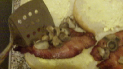 Place the mushrooms onto the bacon already slapped on the bread buns.