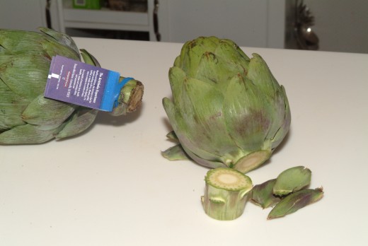Trim the stems and pull off the tiny superficial  leaves from the base of the artichoke.