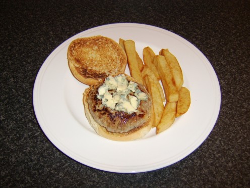 Stilton cheese is crumbled over the pork and apple burger