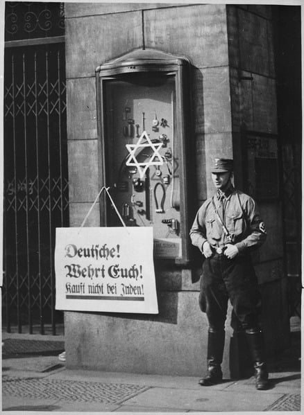 On April 1, 1933, the boycott which was announced by the Nationalsocialistic party began. Placard reads, "Germans, defend yourselves, do not buy from Jews", at the Jewish Tietz store. Berlin. New York Times Paris Bureau Collection.