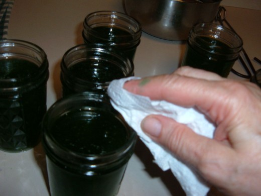 Use a clean cloth or paper towel to wipe off the rim of each jelly jar before you place the lids on.