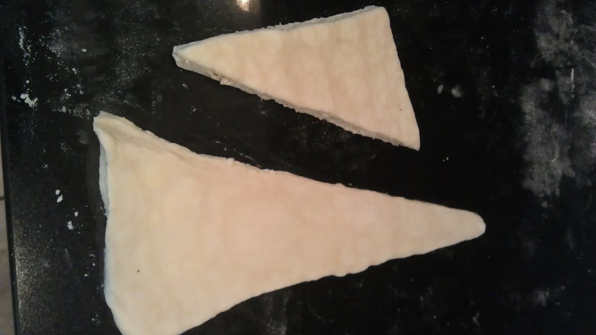 Flour each triangle and roll it out into a large, long isosceles triangle. (The original above for comparison).