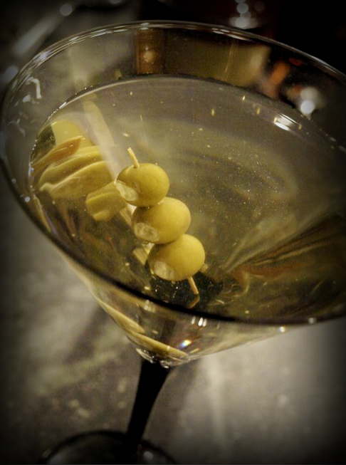 A great recipe for a dirty martini with garlic cheese stuffed olives.