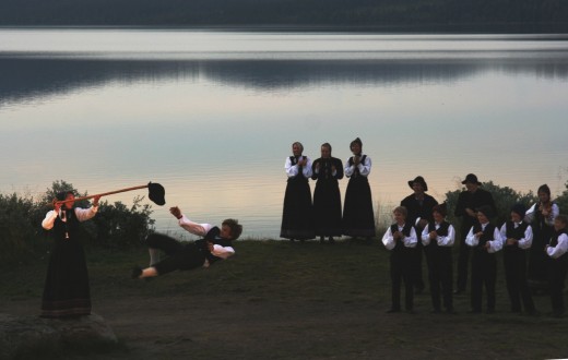 Young boy performing a hallinkast (kick the hat maneuver) in a dancing scene from an outdoors performance of Peer Gynt at Gaalaavannet.  Photo credit:  Marcus Ramberg.