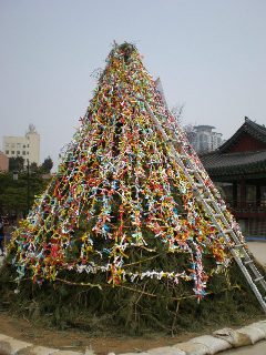 the rope with ribbons of wish is then up to a pile of wood, a structure that looks like wishing tree
