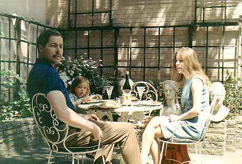Lord and Lady Lucan with one of their little girls at home, in their garden.