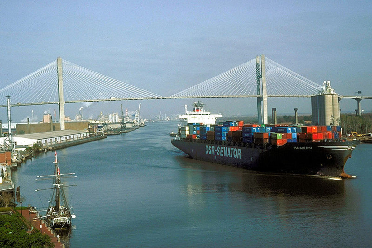 Port of Savannah and Talmadge Memorial Bridge. Ship is sailing down the Savannah River past the Savannah Historic District.
