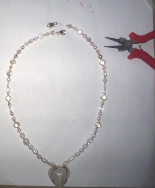 Use jewelry pliers to attach the clasp to each side of the necklace.