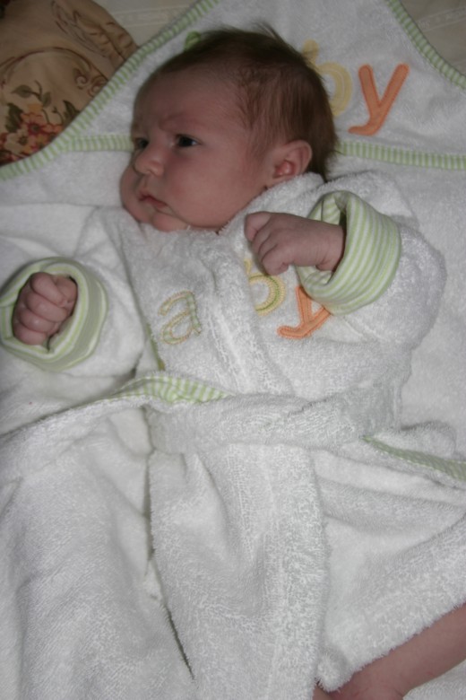 Baby in a robe after bathtime.