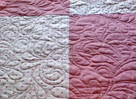 Free-motion quilting is stitched with feed dogs down and is more like drawing with the needle.