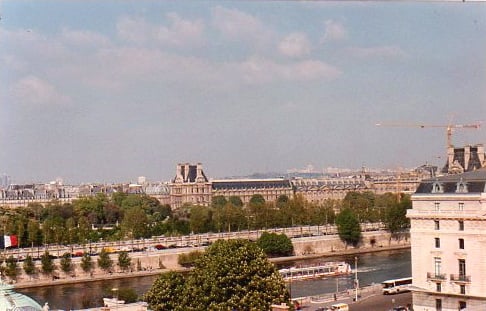 From my window: The Tuilleries gardens, the Louvre, and the busy Seine.