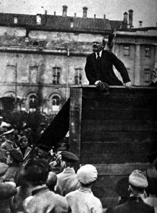 Lenin giving a speech to the troops at the on, May 5, 1920 with Trotsky in foreground. Taken in front of Moscow's Bolshoi Theater. (note that this is only the left half of the original picture; the right half featured Trotsky, so the picture got slic