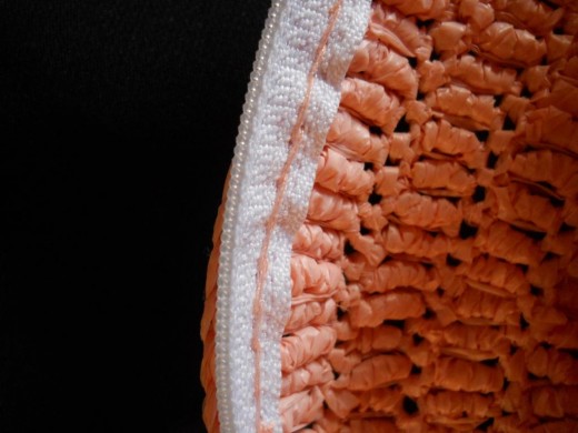 Attach the zipper to the crocheted clutch using back stitches on the 2nd to the last round.