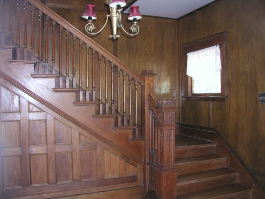 Beautiful Walnut and Pine staircase.  the area beneath the stairway actually opens wide for storage.