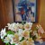 Dr. Robert Rogan painting on wall behind vase of alstroemeria flowers. Dr. Robert Rogan painting on wall behind vase of alstroemeria flowers.
