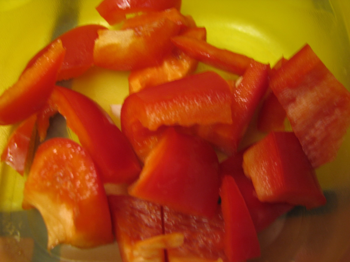 Cut Red Peppers. Cut 1/2 bell pepper into sliced then cut slices in half to make medium chunks