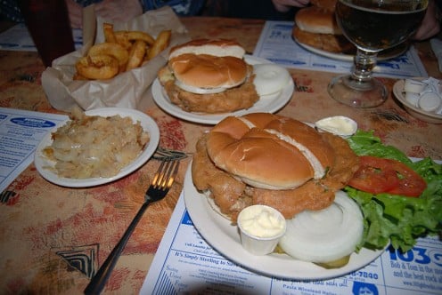 As big as a plate. Served with dill pickles, raw onion, and German Potatoes. Some diners like sliced tomatoes and mayo. 