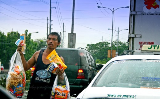 It just rained and this street hawker braved the drizzle just to offer his wares
