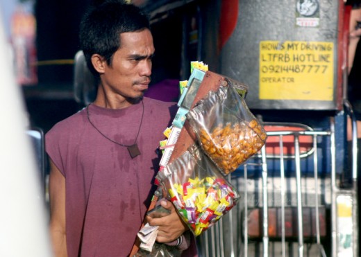 notice the different candy and cigarette brands carried by this man